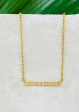 Load image into Gallery viewer, Minimal sleek bar pendant over Marble slab and green leaves