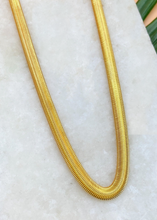 Load image into Gallery viewer, Adira chain in gold over marble slab and green leaves