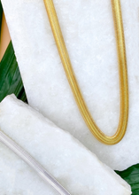 Load image into Gallery viewer, Adira chain in gold and silver over marble slab and green leaves