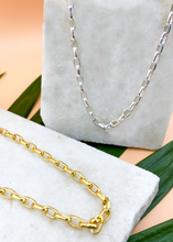 Load image into Gallery viewer, Catena necklace in gold and silver on marble slab with leaves and flowers