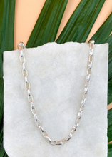 Load image into Gallery viewer, Catena necklace in silver on marble slab with leaves and flowers