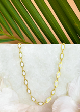 Load image into Gallery viewer, Tia Choker on white marble slab with green leaves and flowers.