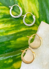 Load image into Gallery viewer, Gold and silver variant of bold hoops earrings on green leaf and marble