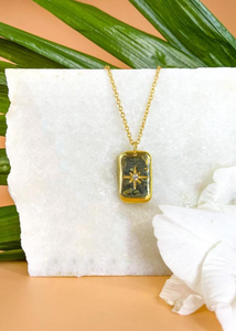 Celeste pendant on marble slab with flowers and leaves