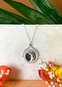 Rotating sun and moon pendant in silver color