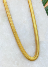 Load image into Gallery viewer, Adira chain in gold over marble slab and green leaves
