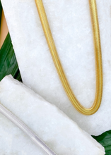 Load image into Gallery viewer, Adira chain in gold and silver over marble slab and green leaves
