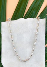 Load image into Gallery viewer, Catena necklace in silver on marble slab with leaves and flowers
