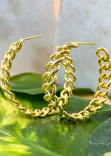 Load image into Gallery viewer, Bold gold hoops earrings with chain structure on green leaves
