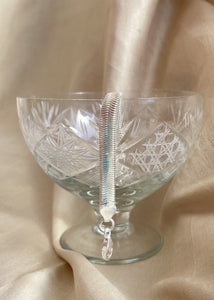 Adira bracelet in silver color in an icecream bowl over golden color