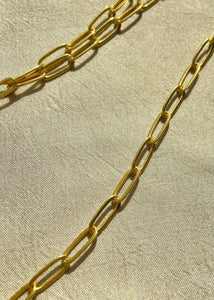 Link Chain on white cloth under sun. 