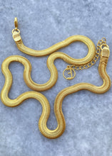 Load image into Gallery viewer, Adira necklace on marble slab in a snake form
