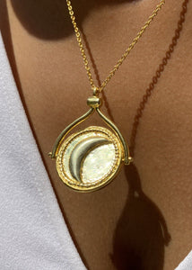 Rotating sun and moon pendant facing moon side