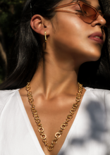 Load image into Gallery viewer, Model wearing Enso necklace and Oblong Earrings with shades
