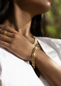 Model wearing Cuban necklace, bracelet and sila ring in outdoor