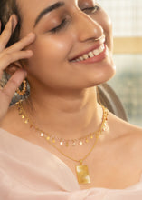 Load image into Gallery viewer, Happy Model wearing Itkan necklace and Minerva Pendant with Twirl earrings
