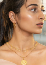 Load image into Gallery viewer, Model wearing twirl earrings, itkan necklace, and Modern maharani pendant looking right wearing pink
