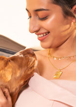 Load image into Gallery viewer, Happy model wearing Minerva Pendant and playing with the dog
